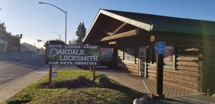 Oakdale Locksmith's log-cabin storefront and green sign on N Yosemite Ave, Oakdale; the sign reads Keys, Locks, Safes, Car Keys, Remotes